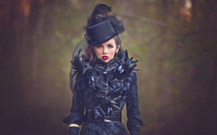 Woman in black top hat and feather boa