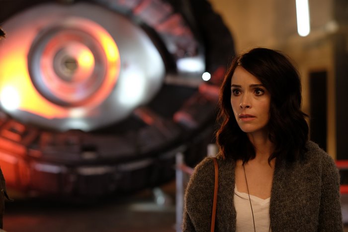 Abigail Spencer in front of a large machine
