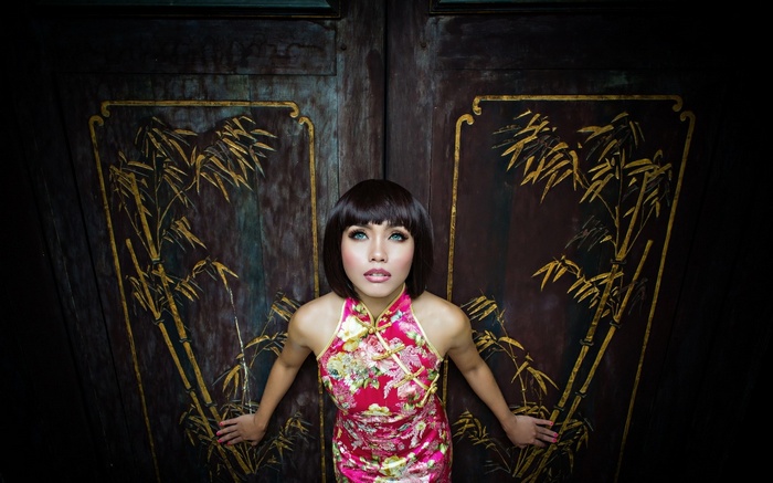 Woman in Cheongsam in front of ornate doors