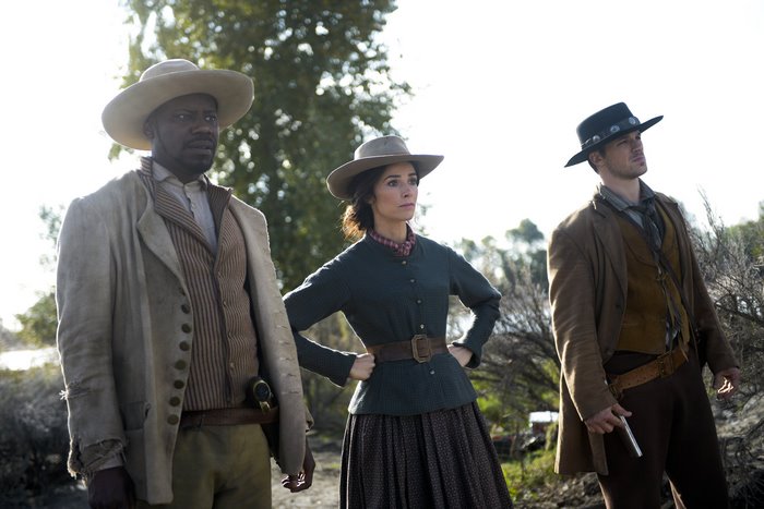 Three people in Western attire outdoors