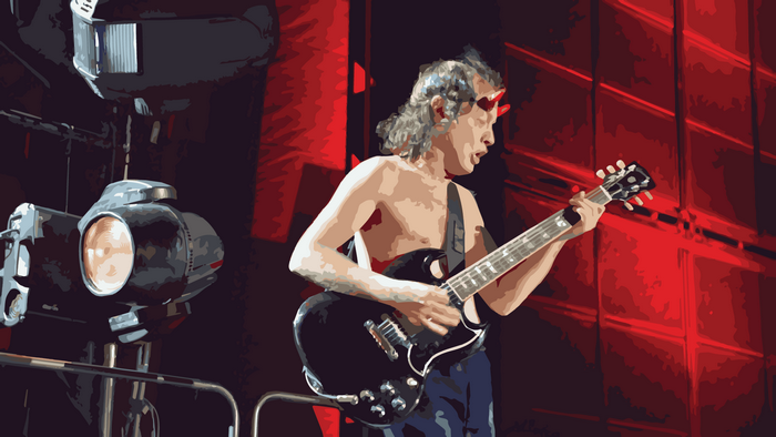 Angus Young from AC/DC playing guitar