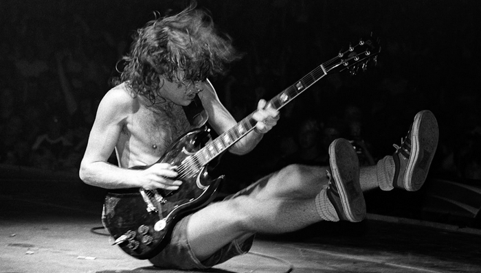 Angus Young playing guitar on stage