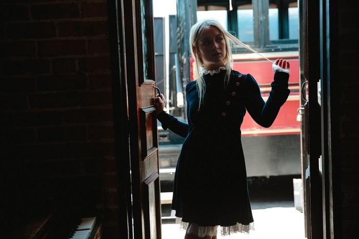 Billie Lourd standing in a doorway