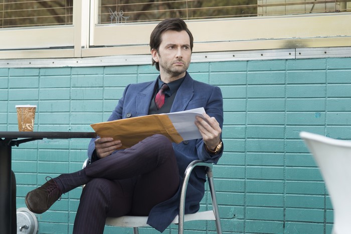 David Tennant holding documents