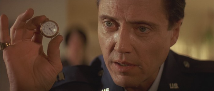 Christopher Walken holding a pocket watch