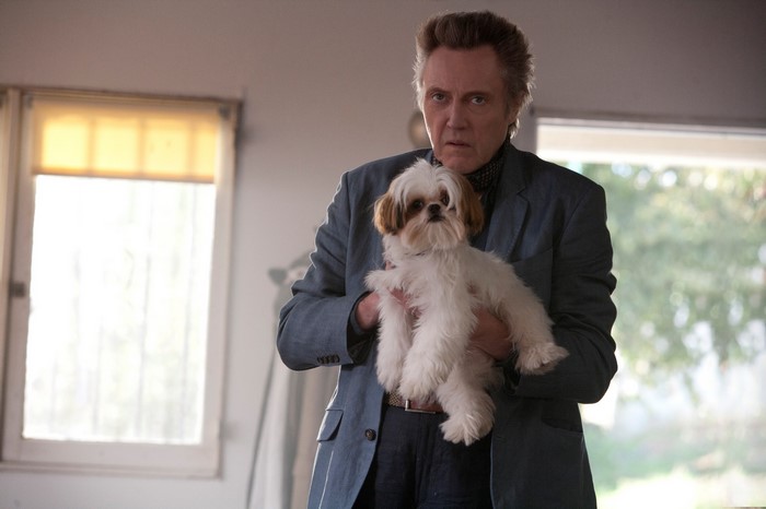 Christopher Walken holding a Shih Tzu dog