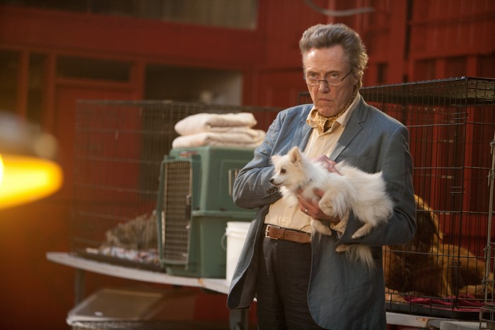 Christopher Walken holding a small white dog