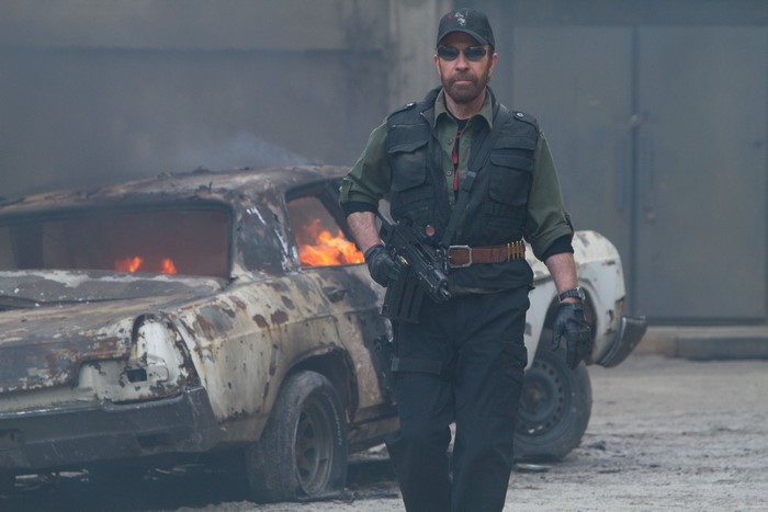 Chuck Norris with a burning car