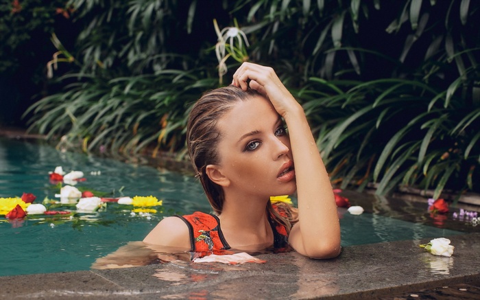 Woman in pool with flowers