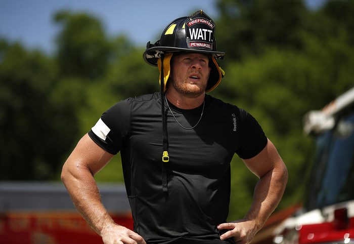 J.J. Watt wearing a firefighter helmet