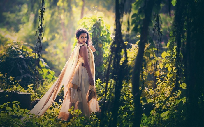 Woman in traditional Indian attire in a forest