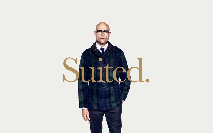 Mark Strong in a plaid jacket with text Suited.