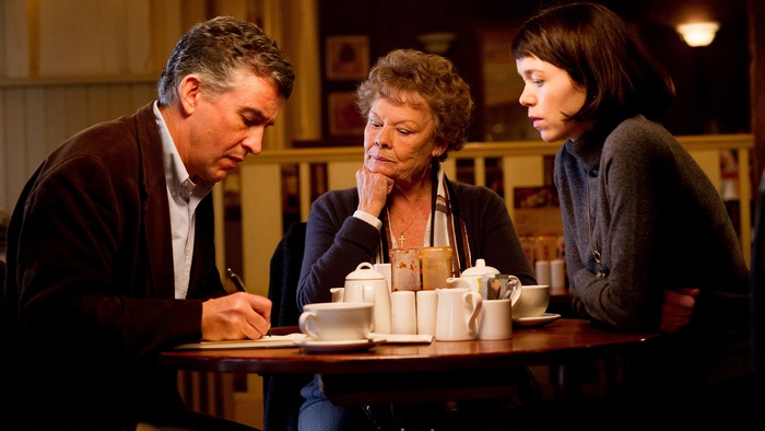 Judi Dench and two people at a table