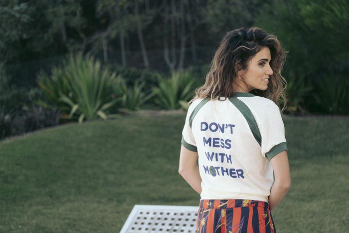 Nikki Reed wearing a t-shirt with text