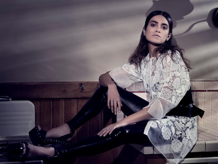 Nikki Reed sitting on a counter