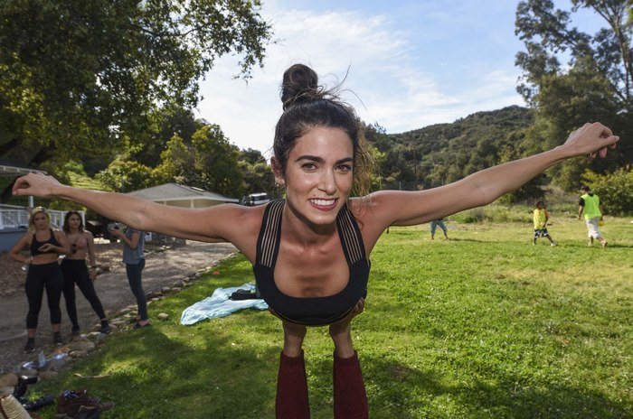 Nikki Reed performing acroyoga outdoors