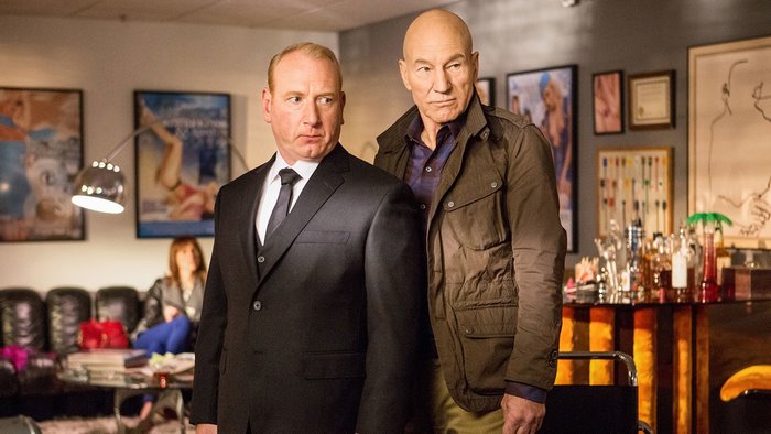 Patrick Stewart and man in suit in room