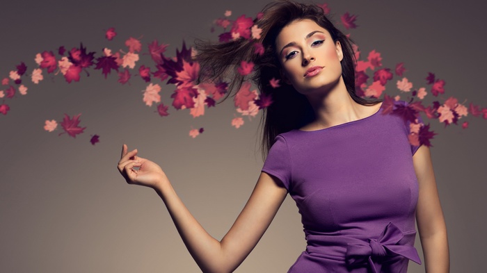 Woman in purple dress with falling leaves