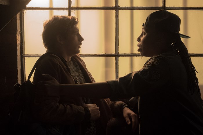 Tye Sheridan and another person by a window