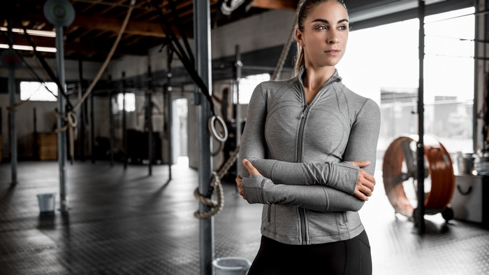 Woman in gym attire standing in a gym