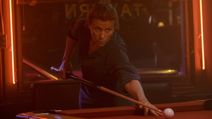 Frances McDormand playing pool in a bar