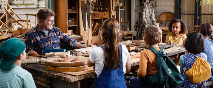 Robert Redford with children in a workshop