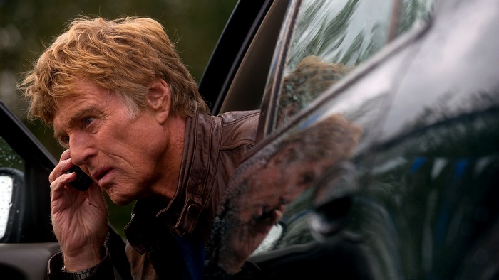 Robert Redford on the phone in a car