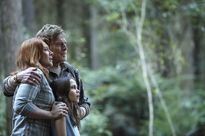Robert Redford with two women in a forest