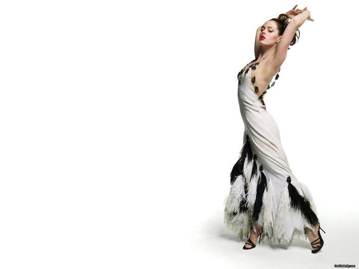 Rose McGowan in a white dress with feathers