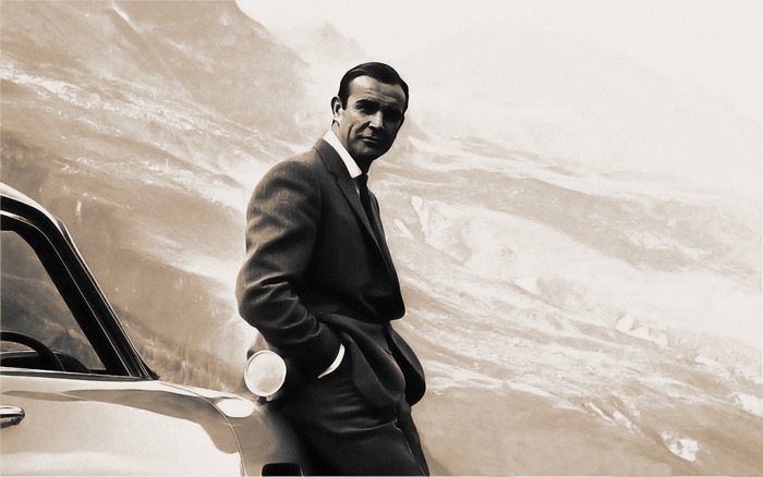 Sean Connery leaning on a car in mountains