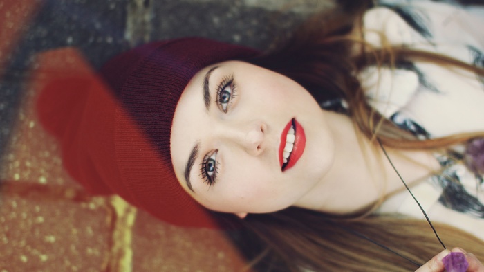 Young woman with red beanie and red lipstick
