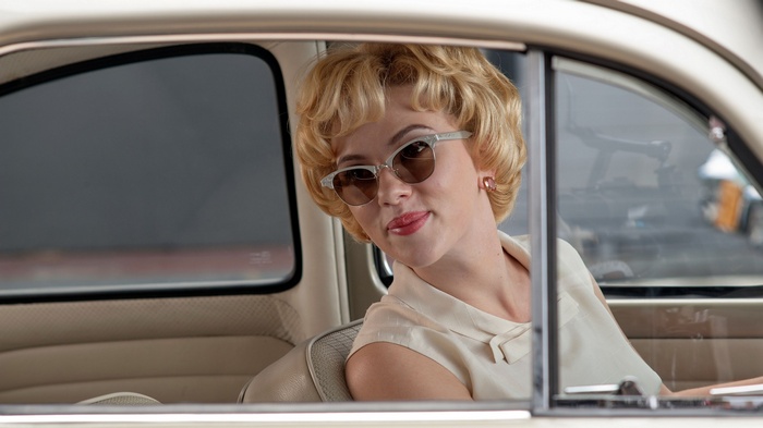 Blonde woman in sunglasses in a car
