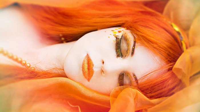 Woman with orange hair and makeup