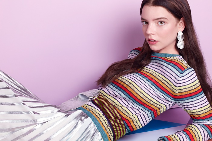 Anya Taylor-Joy in a colorful striped top and silver skirt