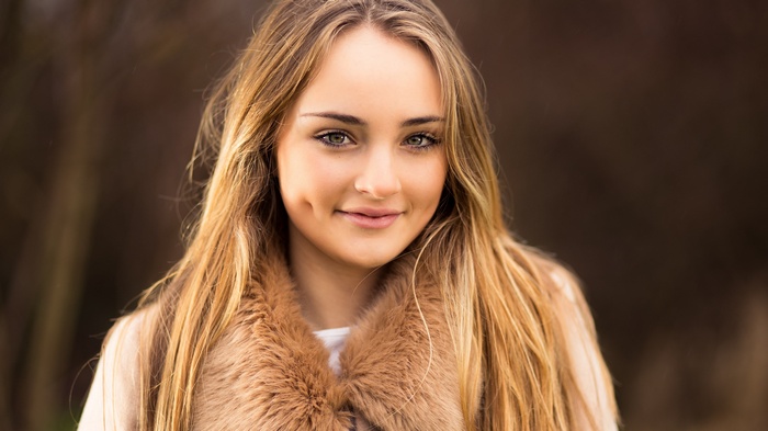 Young woman with blonde hair and dimples