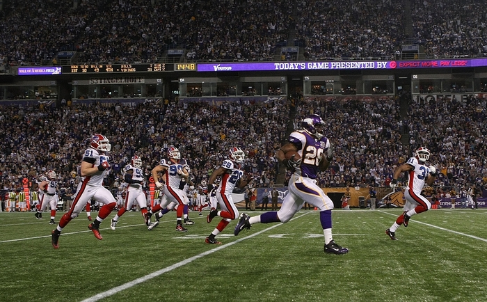 Adrian Peterson running with football in stadium