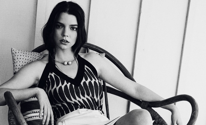 Anya Taylor-Joy sitting in a chair