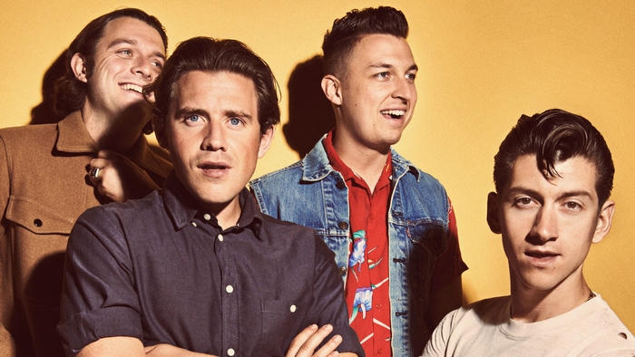 Arctic Monkeys band members posing for a photo
