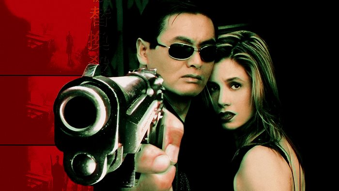 Chow Yun-Fat holding a gun with a woman