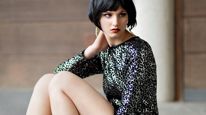 Woman in sequined dress with short black hair