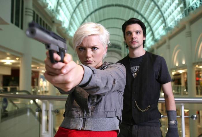 Hannah Spearritt holding a gun