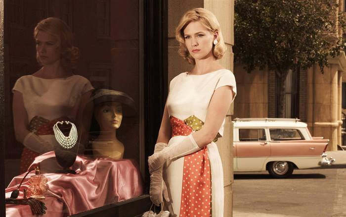 January Jones in a white dress with polka dot sash