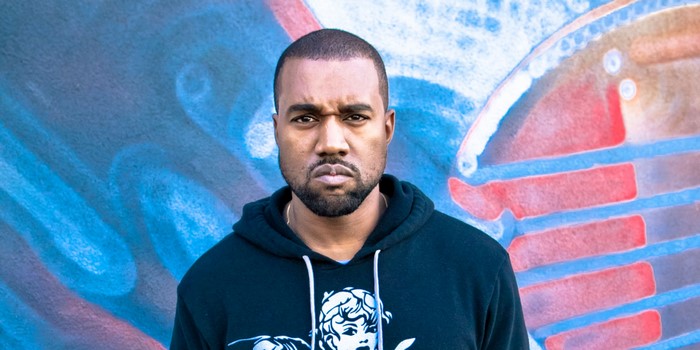 Kanye West in front of graffiti art