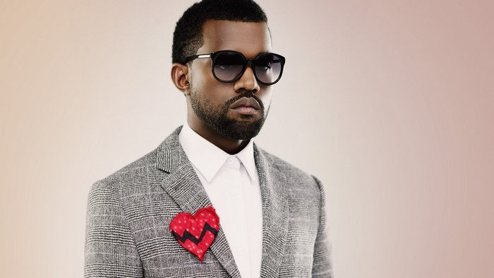 Kanye West wearing a suit and sunglasses