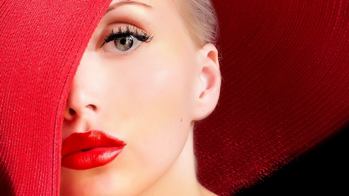 Woman in a red hat with red lipstick