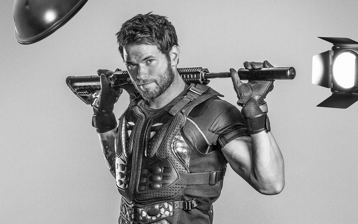 Kellan Lutz holding a rifle