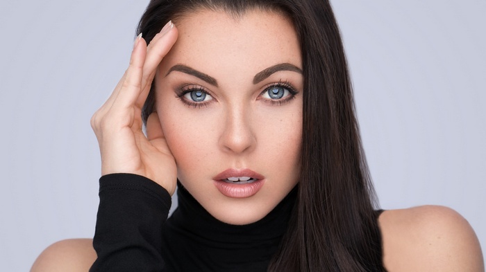 Woman with hand on forehead