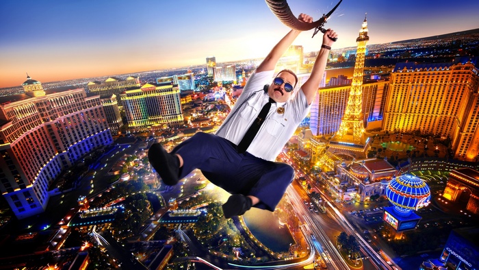 Kevin James as a police officer ziplining over Las Vegas