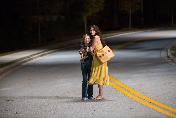 Margaret Qualley and a young girl on a road