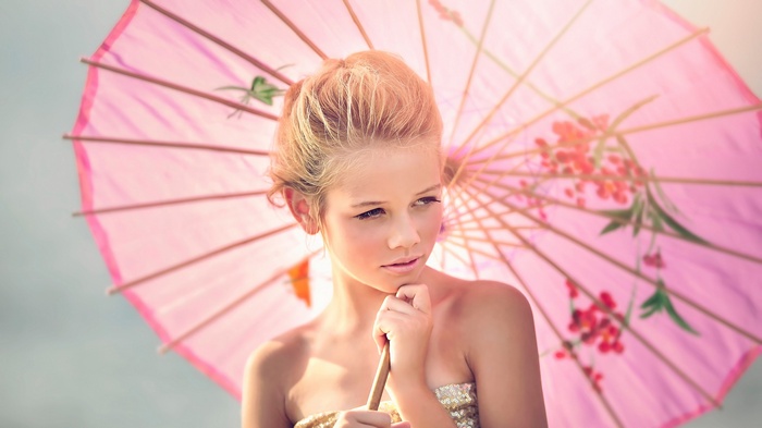 Girl holding a pink umbrella